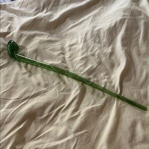 Elegant long, stemmed, green glass display item